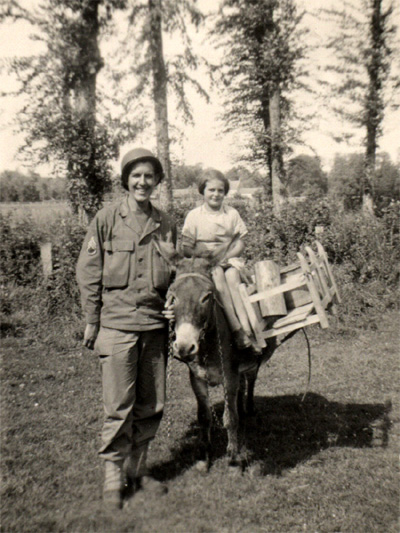 S/Sgt Herbert Landers, 14th Chemical Maintenance Company and young French girl on a donkey