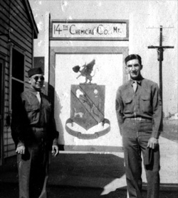 T/4 Harold Andrews and 1st/Sgt Edward Crawford in front of 14th company crest, Camp Gordon, Georgia, October-November 1943